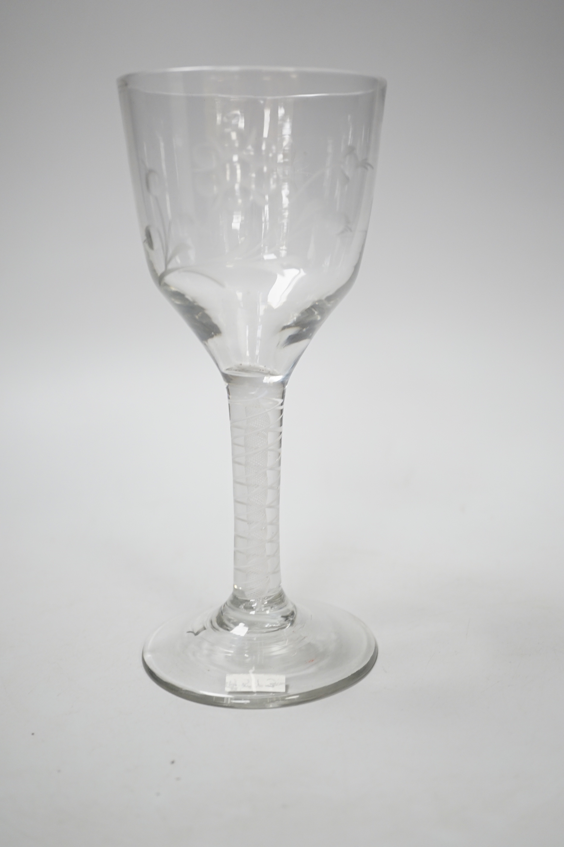 An English lead crystal DSOT goblet, c.1760, ogee bowl with tool marks and engraved with polished flora opposite a single insect which appears to be a bee, two spiral tapes around a gauze, conical foot, broken pontil, 18